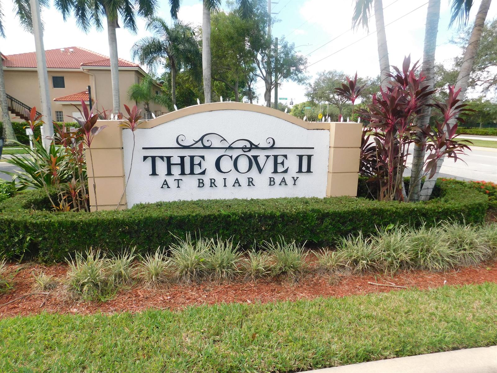 A white monument sign for The Cove II at Briar Bay stands outdoors — 3800 N Jog Road # 204, West Palm Beach FL 33411, WEST PALM BEACH, FL