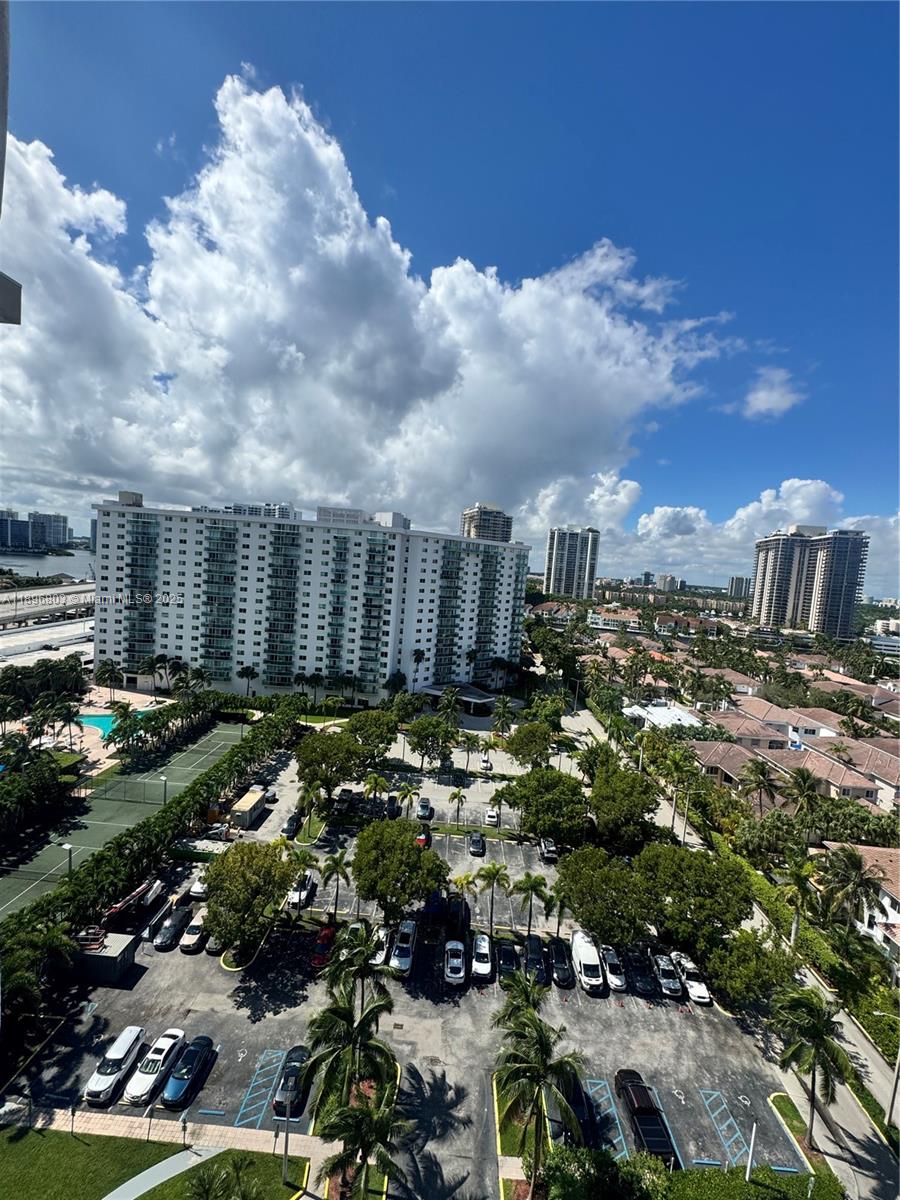 An elevated view shows a parking lot, palm trees, and high-rise buildings under a blue sky — 19370 Collins Ave # 1520, Sunny Isles Beach FL 33160, SUNNY ISLES BEACH, FL