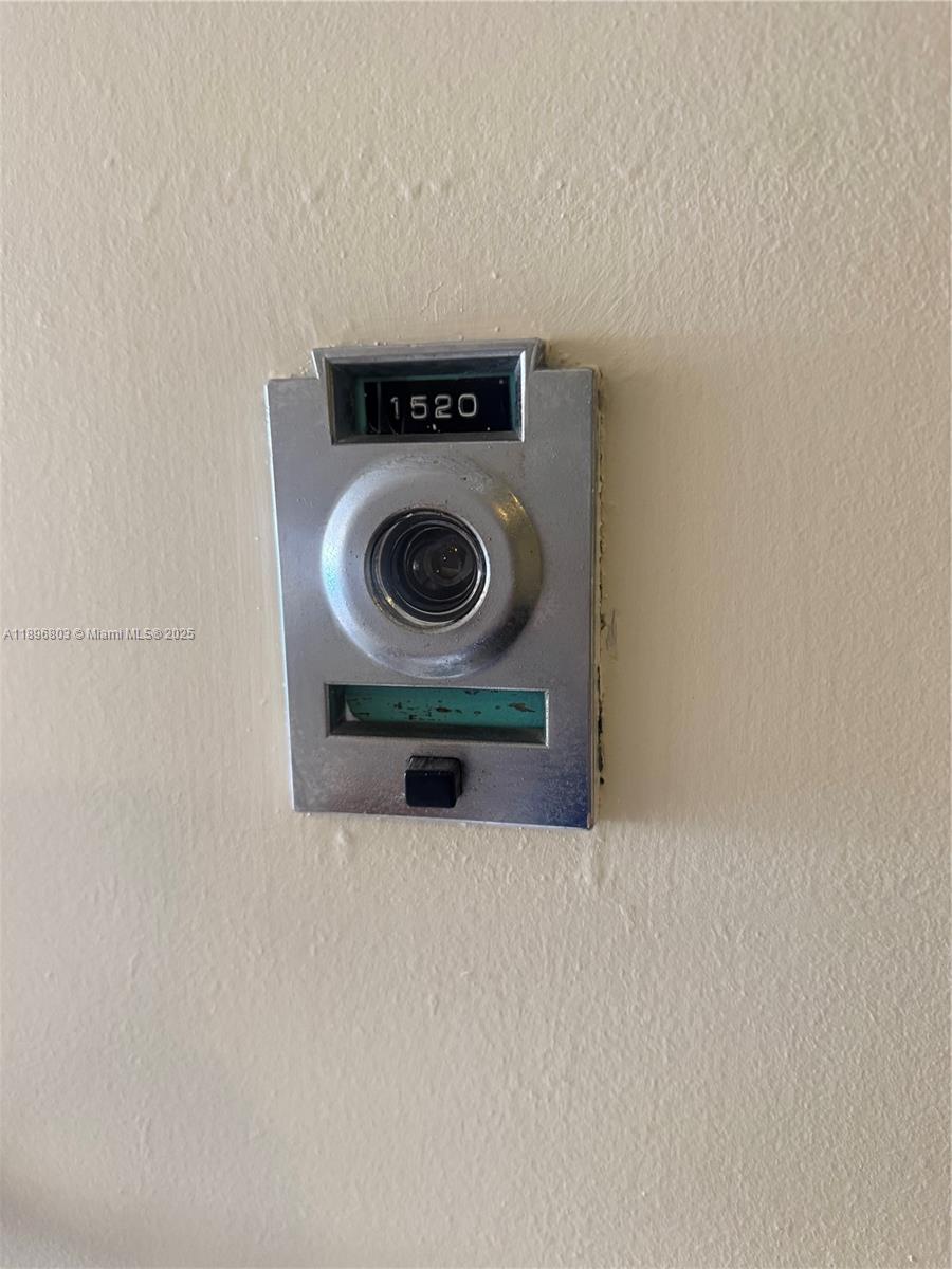A vintage metal doorbell with a built-in peephole and unit number 1520 is mounted on a wall — 19370 Collins Ave # 1520, Sunny Isles Beach FL 33160, SUNNY ISLES BEACH, FL