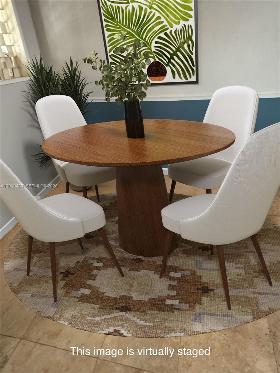This is a virtually staged dining area featuring a round wooden table and four chairs — 224 NE 47th St, Miami FL 33137, MIAMI, FL
