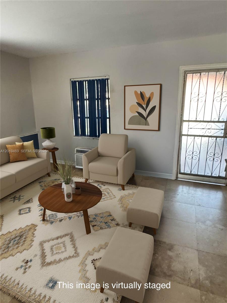 This virtually staged living room features tile flooring, a beige sofa, an armchair, and ottomans — 224 NE 47th St, Miami FL 33137, MIAMI, FL