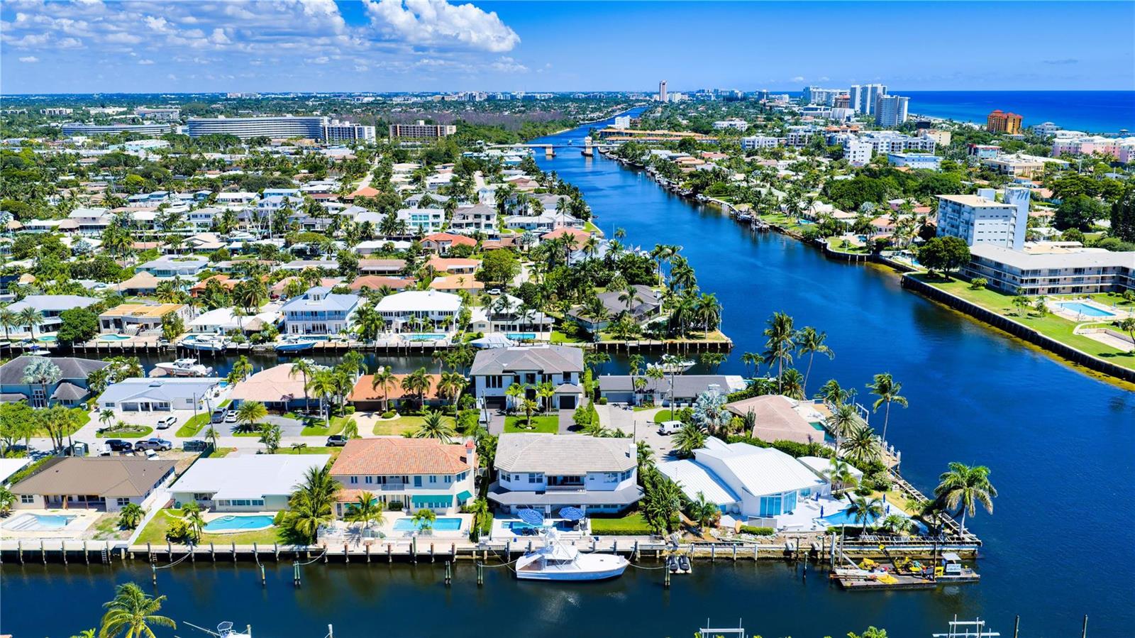 An aerial view of waterfront houses along a canal leading to the ocean — 1580 SE 8th Street, Deerfield Beach FL 33441, DEERFIELD BEACH, FL