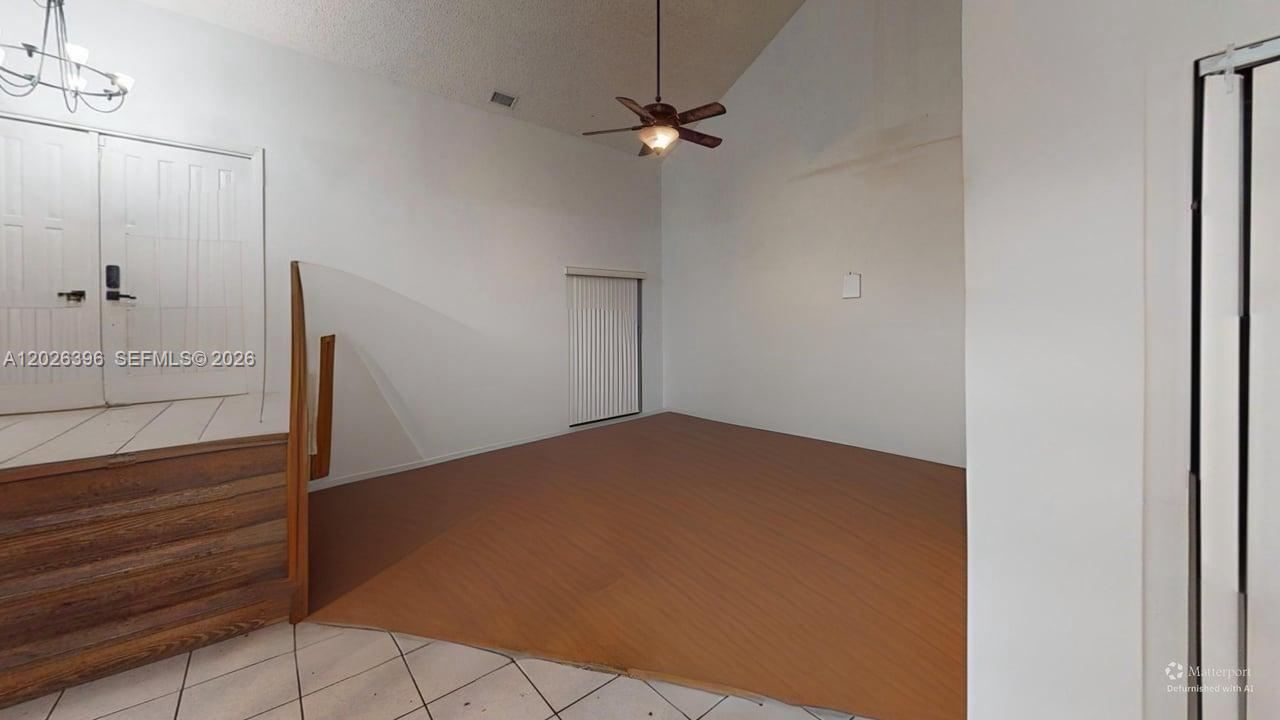 A living room features vaulted ceilings, a ceiling fan, and wood-look flooring — 15552 SW 54th Ter, Miami FL 33185, MIAMI, FL