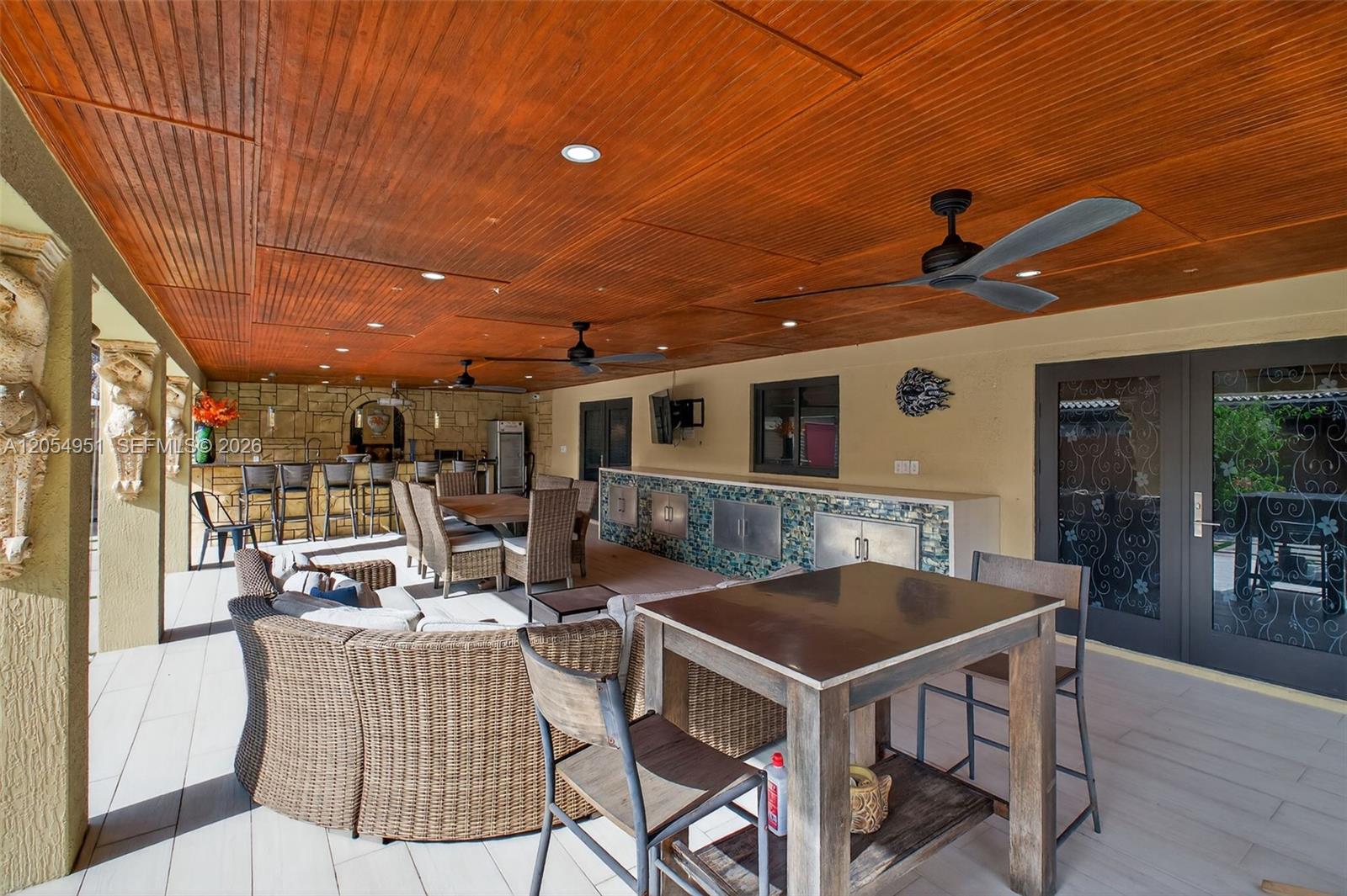 A covered outdoor patio features a wooden ceiling, a bar area, and multiple seating arrangements — 2431 SW 127th Ave # 2431, Miami FL 33175, MIAMI, FL