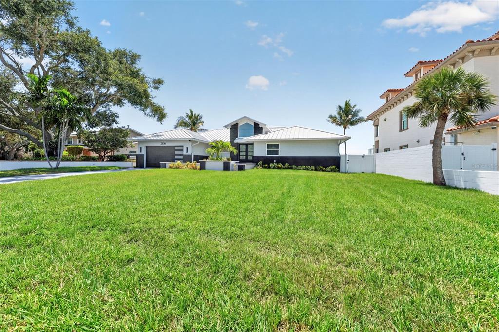 A single-story house with a metal roof and a large front lawn — 2936 68TH AVENUE S, ST PETERSBURG, FL
