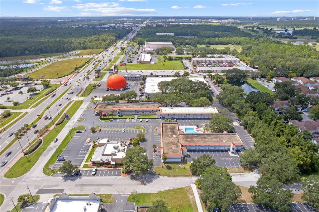 An aerial view shows a hotel complex with a large orange-shaped structure and pool — 5367 W IRLO BRONSON MEMORIAL HIGHWAY UNIT 1-117, KISSIMMEE, FL