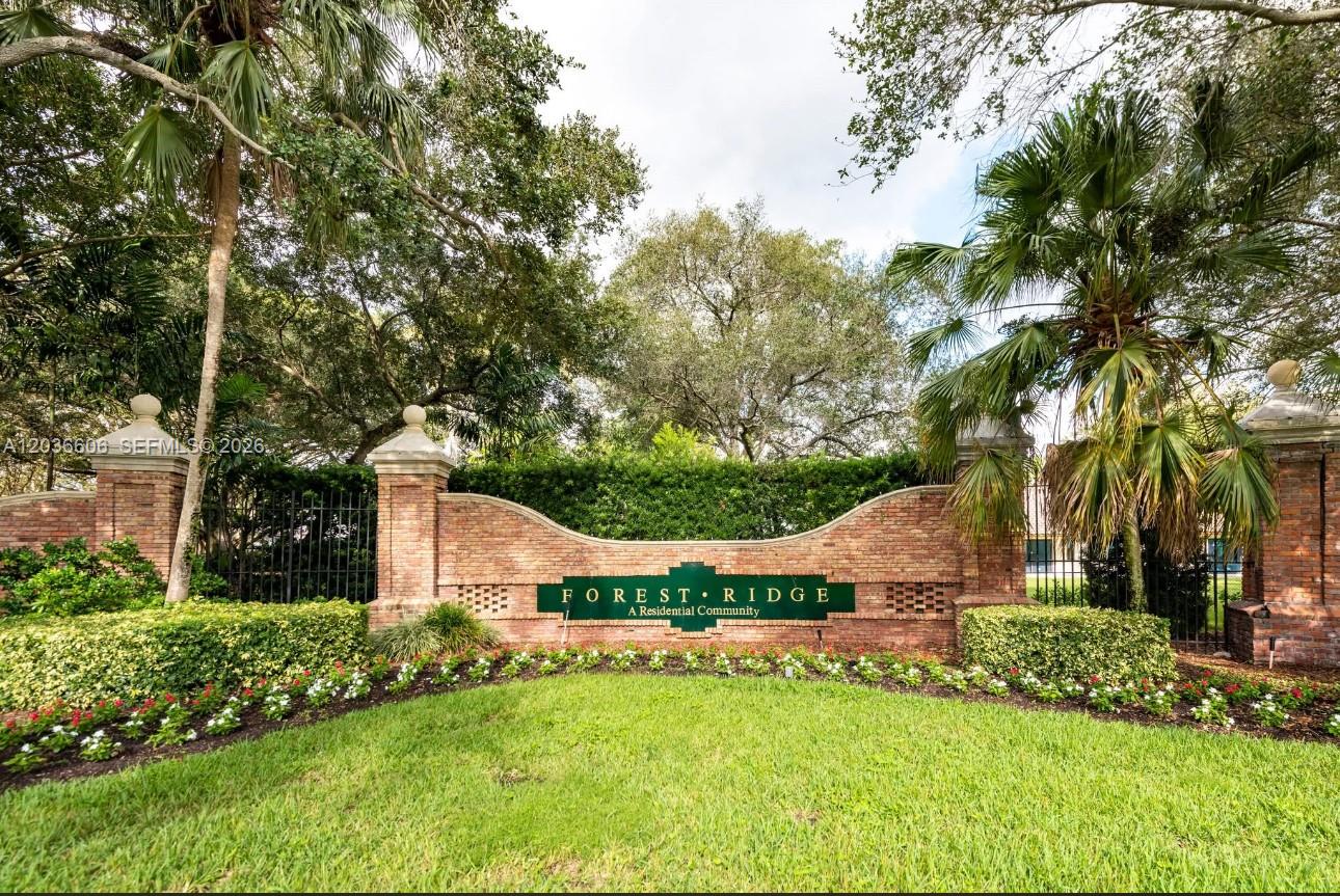 A two-story light blue house with a tiled roof, palm trees, and landscaped front yard — 8815 Woodside Ct, Davie FL 33328, DAVIE, FL