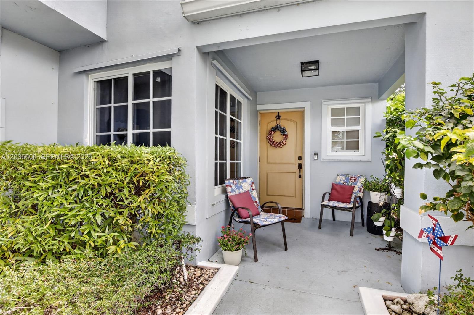 A brick driveway leads through a gated entrance flanked by brick pillars and large trees — 8815 Woodside Ct, Davie FL 33328, DAVIE, FL