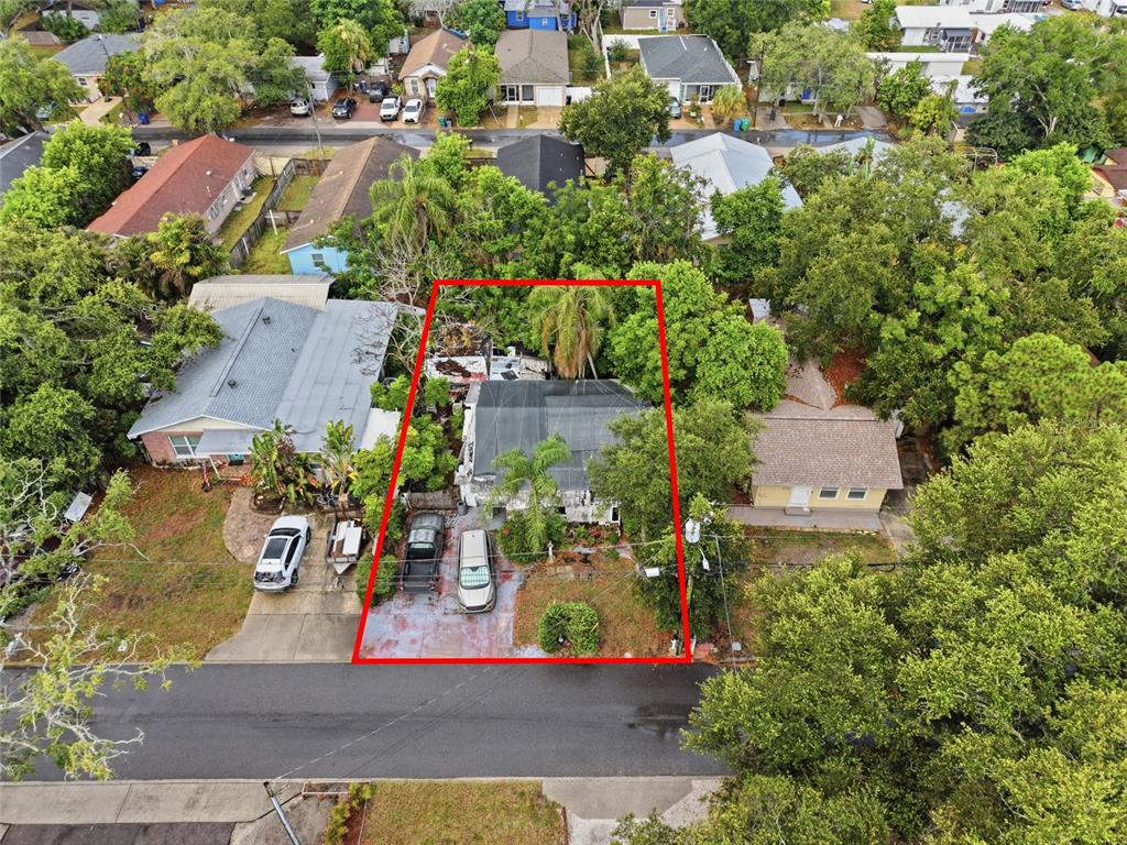 An aerial view shows a single-story house with a screened porch and driveway — 1734 CRAWFORD AVENUE, CLEARWATER, FL