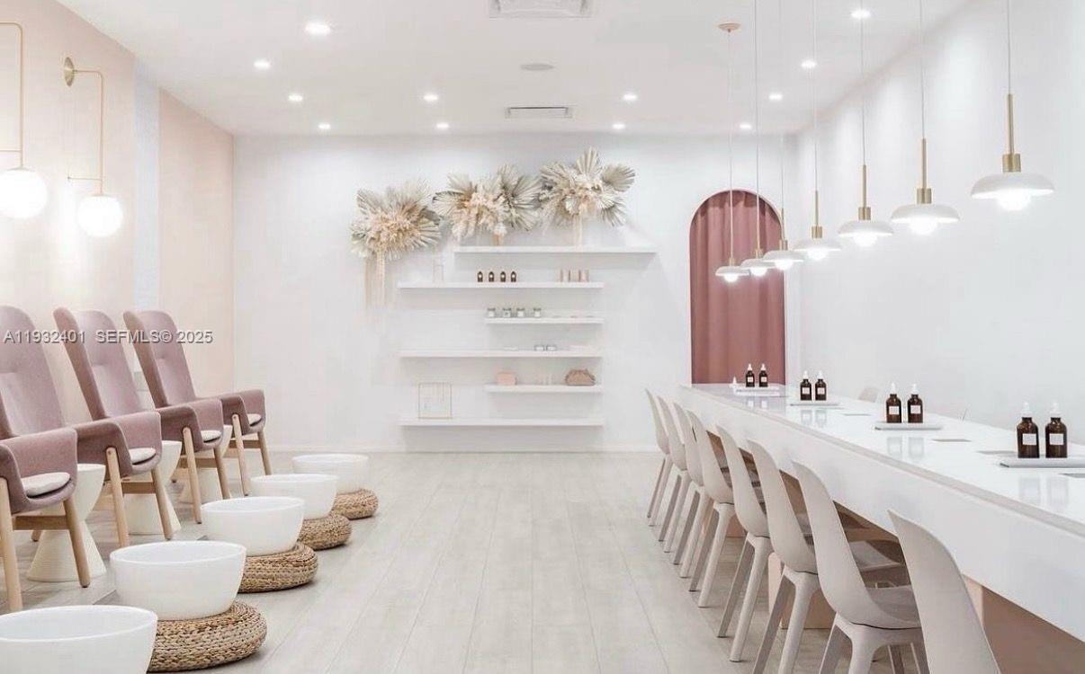 A bright salon interior features pedicure stations, a long manicure table, and minimalist white decor — 240-290 N Federal Highway, Fort Lauderdale FL 33301, FORT LAUDERDALE, FL
