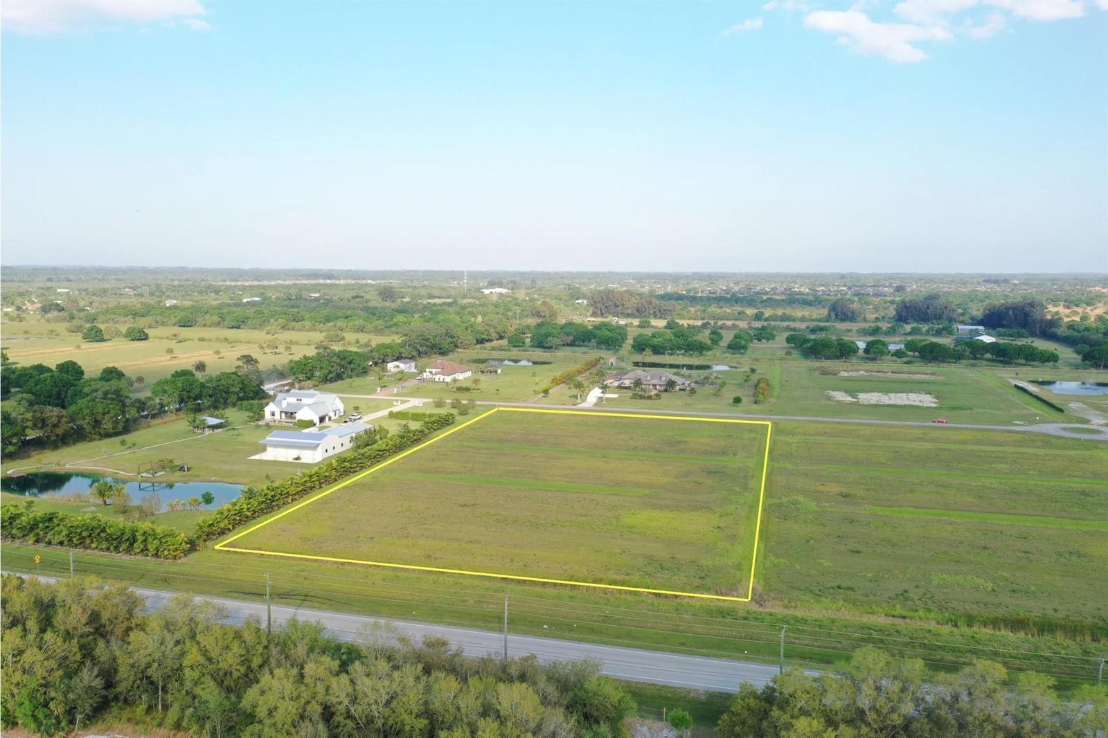 An aerial view shows a rectangular vacant lot outlined in yellow next to a road — 555 65th Avenue, Vero Beach FL 32968, VERO BEACH, FL