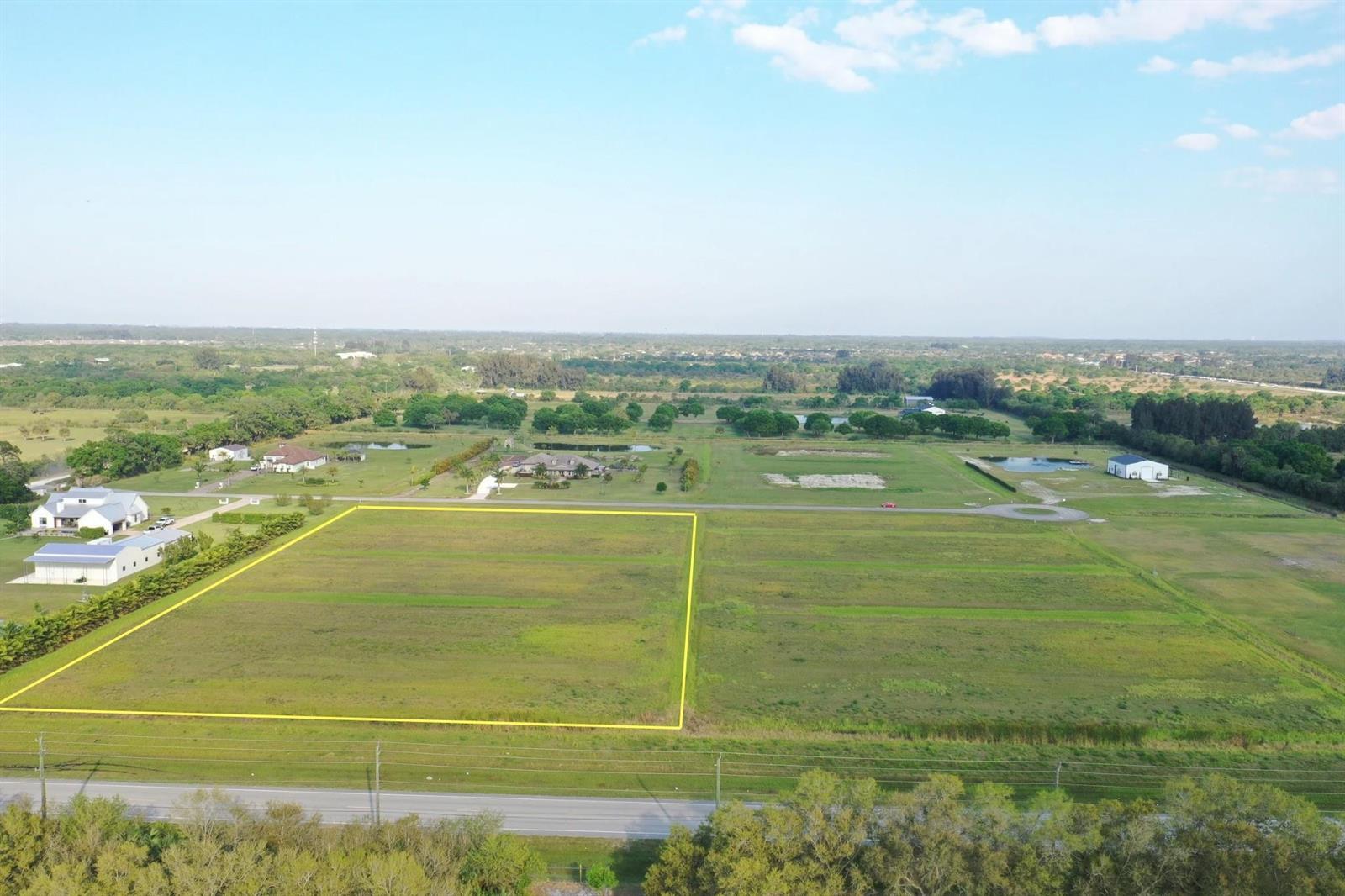 An aerial view shows a large, rectangular vacant lot outlined in yellow near a road — 555 65th Avenue, Vero Beach FL 32968, VERO BEACH, FL