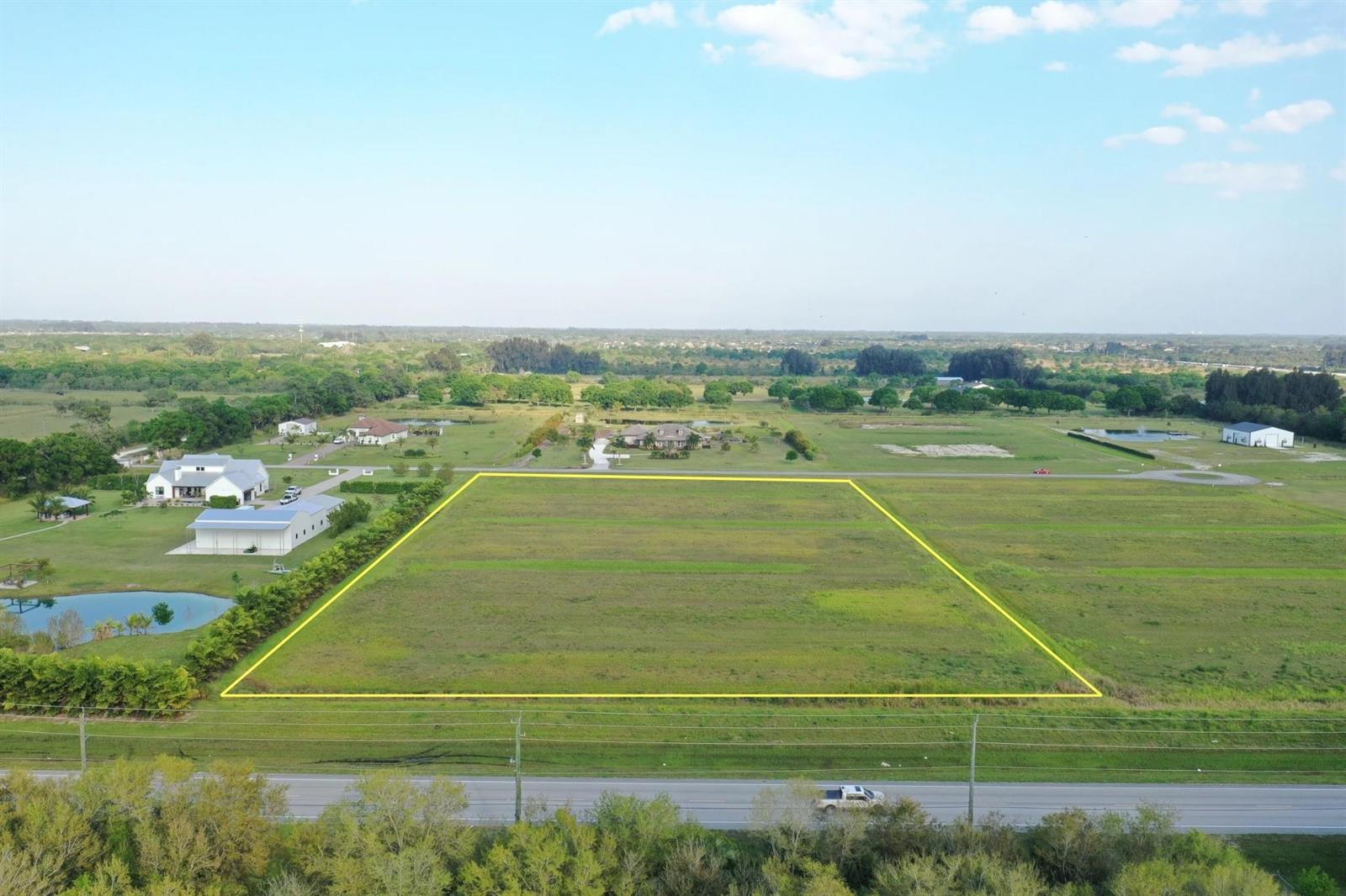 An aerial view shows a rectangular vacant lot outlined in yellow next to a road — 555 65th Avenue, Vero Beach FL 32968, VERO BEACH, FL