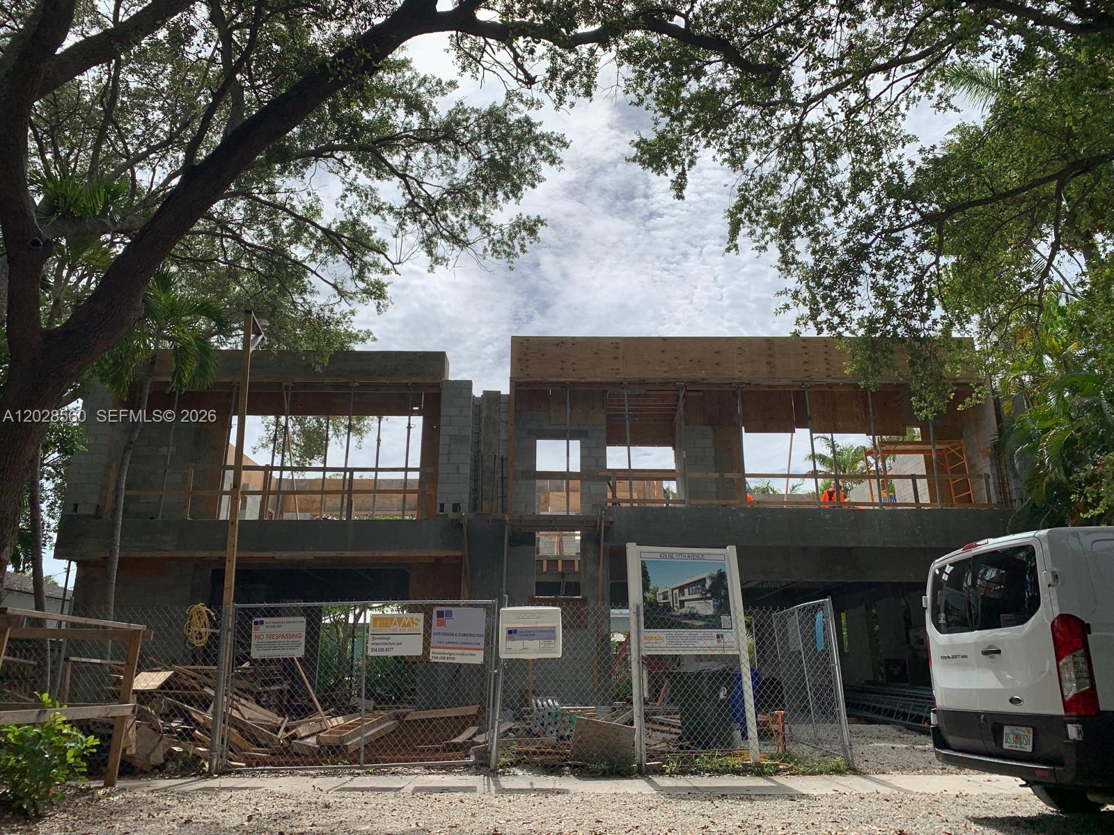 A two-story concrete residential structure under construction behind a chain-link fence — 428 NE 17th Ave, Fort Lauderdale FL 33301, FORT LAUDERDALE, FL