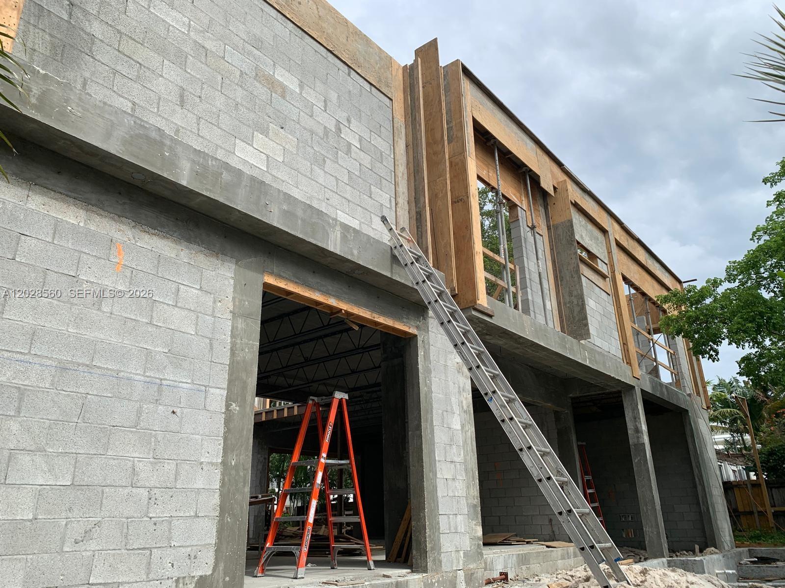 An exterior view of a building under construction with concrete block walls and wooden framing — 428 NE 17th Ave, Fort Lauderdale FL 33301, FORT LAUDERDALE, FL