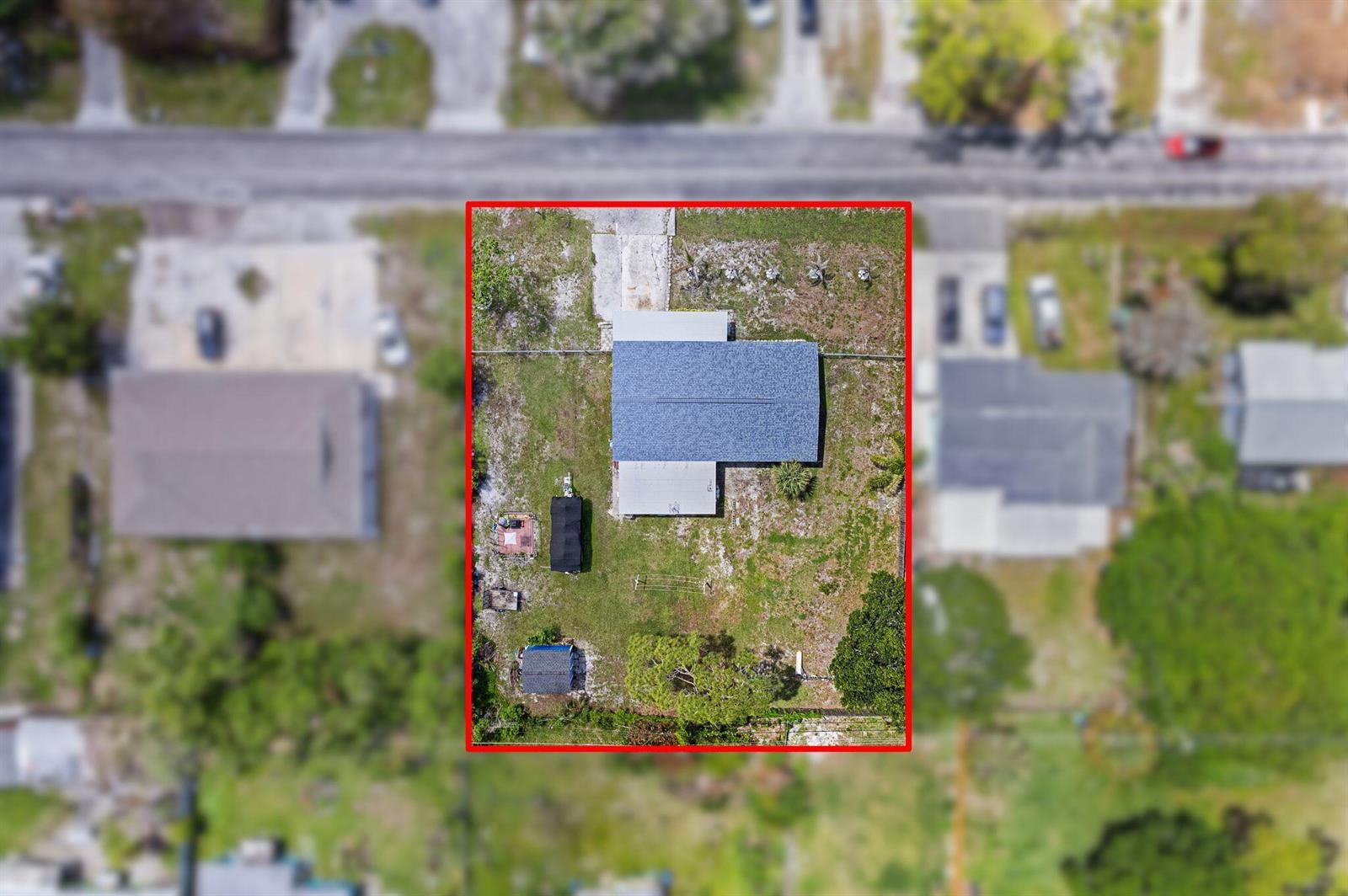 An aerial view shows a blue house with a gray roof and a red location pin — 3108 Mura Drive, Fort Pierce FL 34982, FORT PIERCE, FL