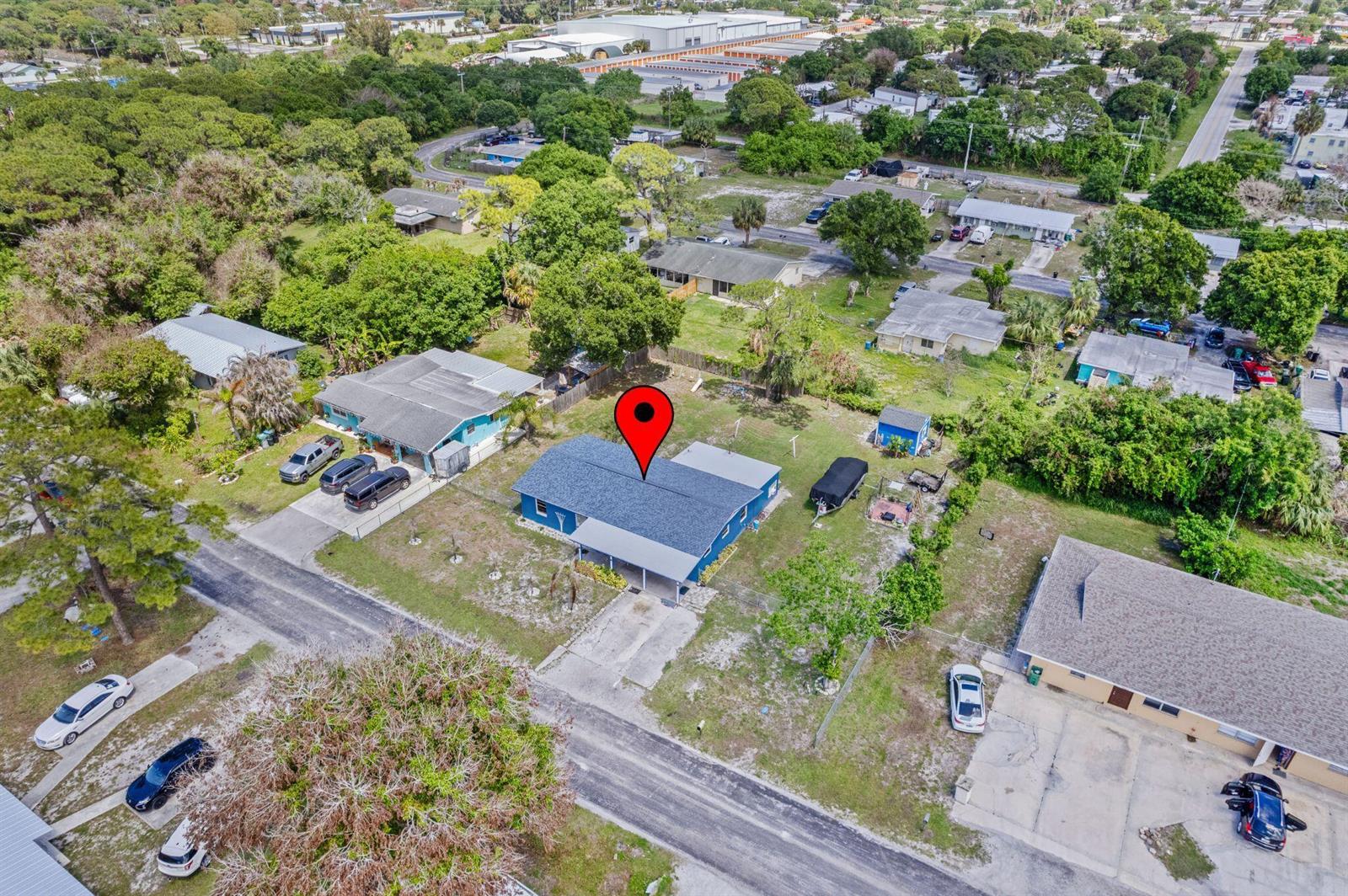 An aerial view shows a house with a blue roof on a rectangular lot — 3108 Mura Drive, Fort Pierce FL 34982, FORT PIERCE, FL