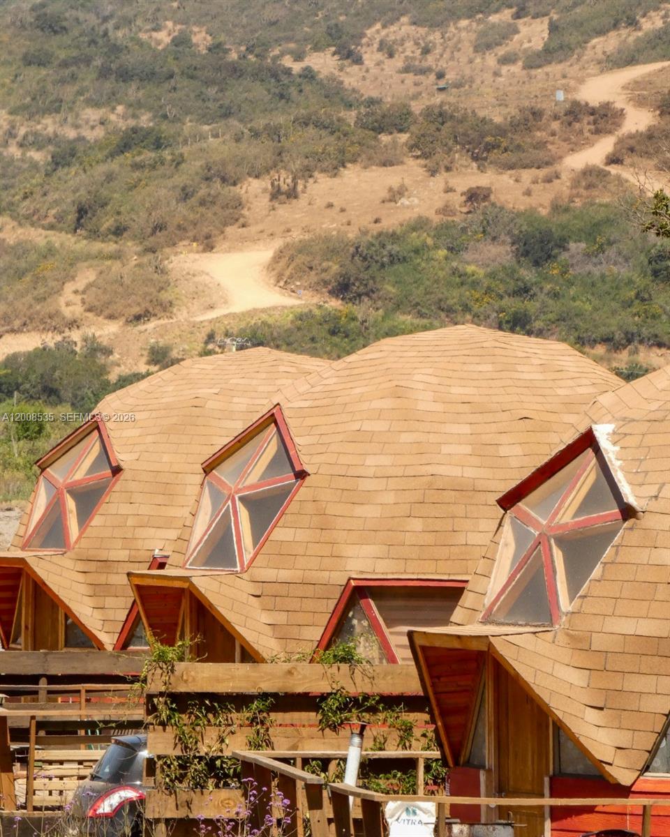 Exterior view of several connected geodesic dome structures with shingled roofs and pentagonal windows — LODGE FOR SALE Santo Domigo (Chile), 2720000, FL