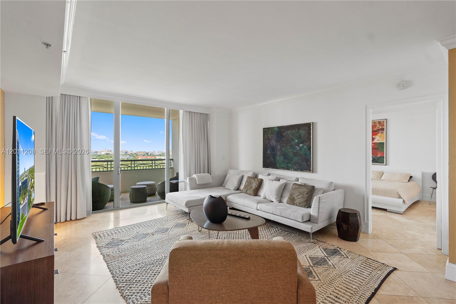 A living room features a white sectional sofa, a tan armchair, and a gold accent wall — 3400 SW 27th Ave # 1505, Coconut Grove FL 33133, COCONUT GROVE, FL