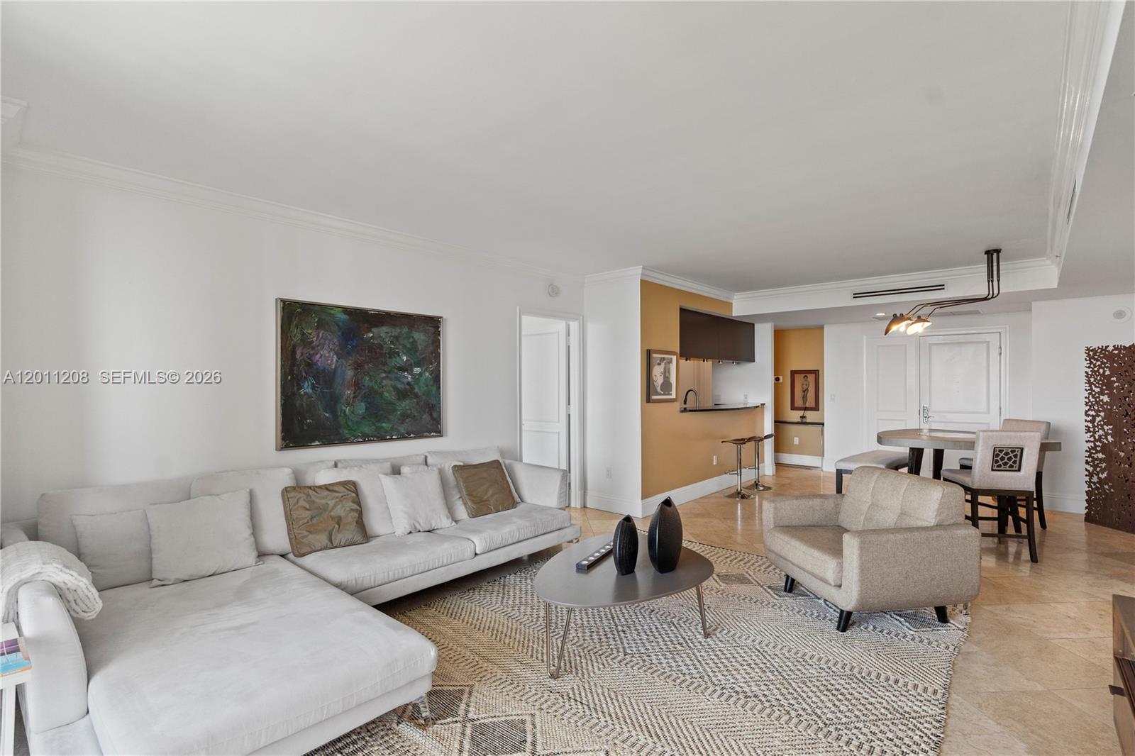 A balcony with wicker furniture overlooks a city skyline and a modern glass building — 3400 SW 27th Ave # 1505, Coconut Grove FL 33133, COCONUT GROVE, FL