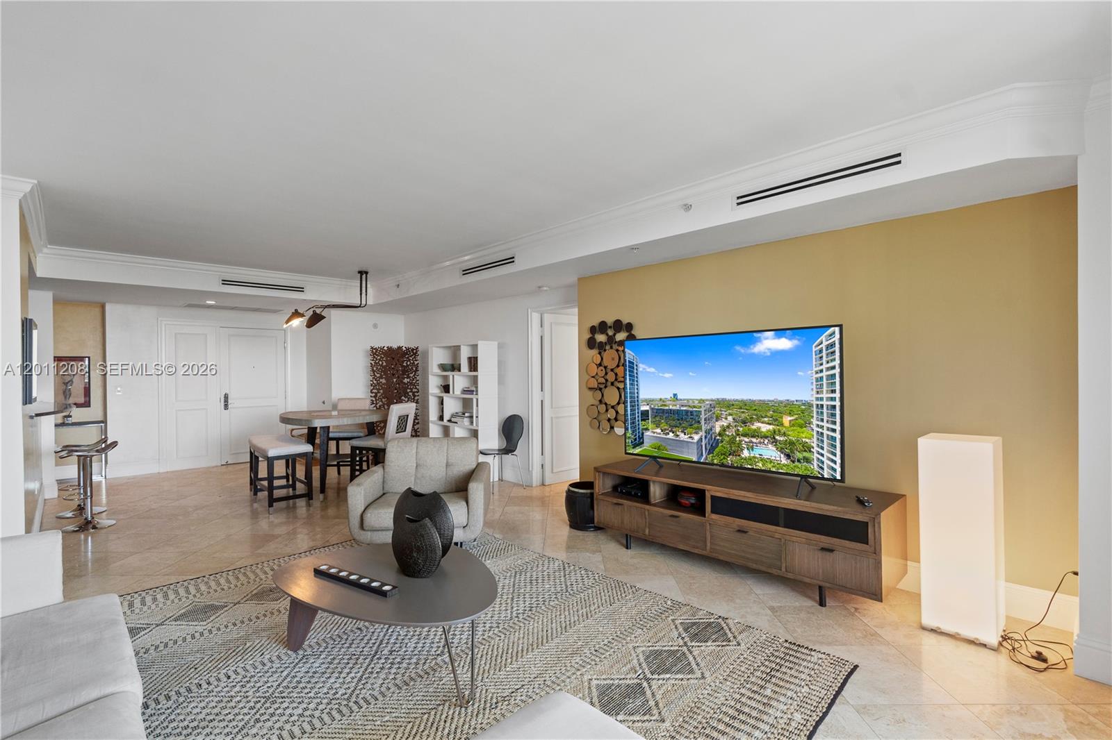 A living room features a sectional sofa, area rug, and balcony with an outdoor view — 3400 SW 27th Ave # 1505, Coconut Grove FL 33133, COCONUT GROVE, FL