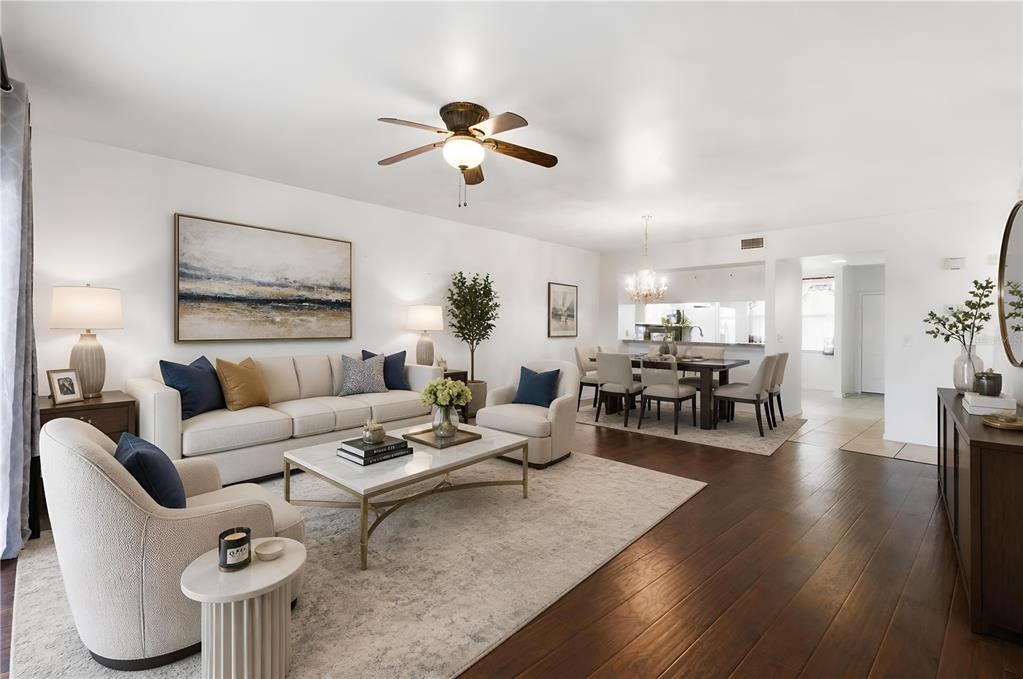 A living room and dining area feature hardwood floors, neutral furniture, and a ceiling fan — 960 STARKEY ROAD UNIT 2403, LARGO, FL