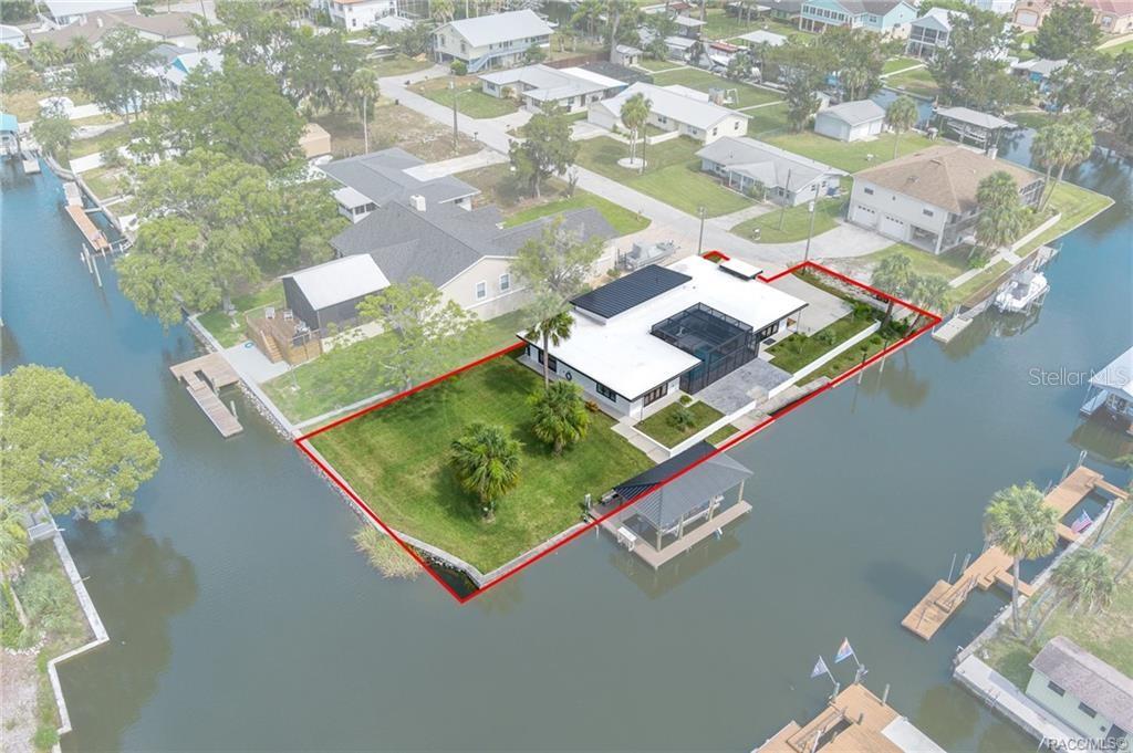 An aerial view of a waterfront home with a large lawn and private boat dock — 1941 NW 17TH STREET, CRYSTAL RIVER, FL
