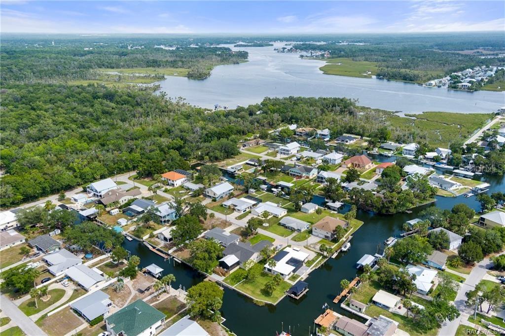An aerial view shows houses situated along a network of canals leading to a bay — 1941 NW 17TH STREET, CRYSTAL RIVER, FL