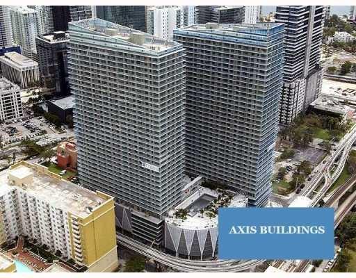 An aerial view shows two tall, modern glass residential towers connected by a shared podium — 1111 SW 1st Ave, Miami FL 33130, MIAMI, FL