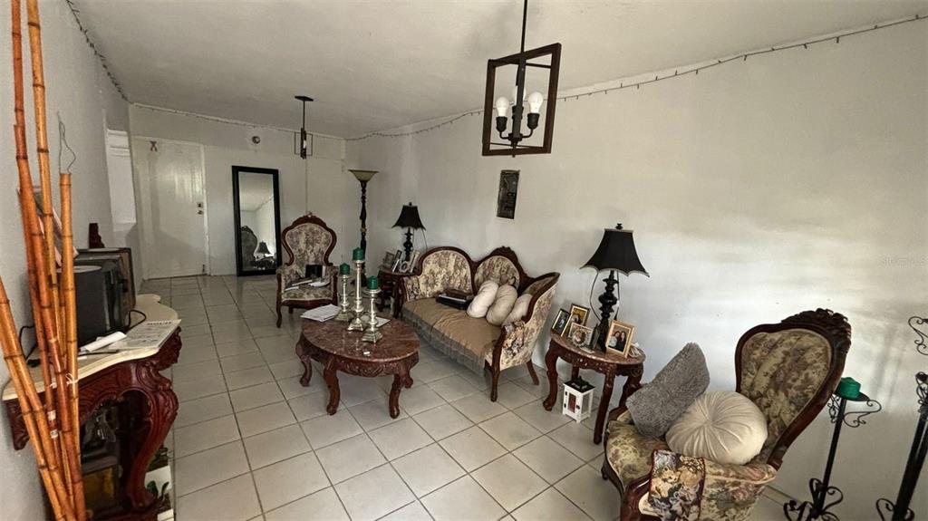 A living room features tiled floors, traditional furniture, and a dark wood chandelier — 26 BO FACTOR 1 PARCELAS ANIMAS #399 CALLE 26, ARECIBO, PR