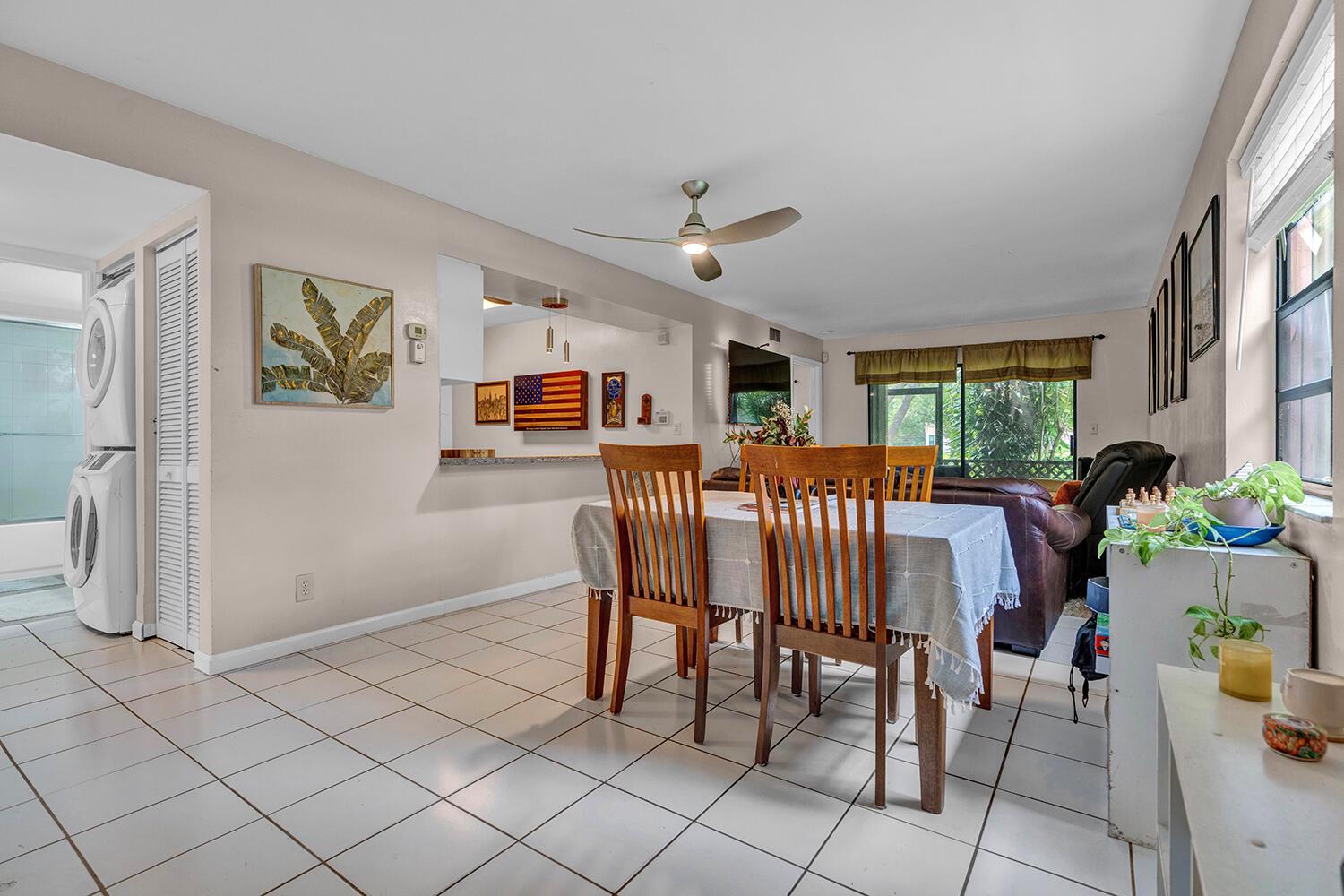 A dining area with a table, tile floors, and an open view into the kitchen — 3191 Leewood Terrace # L138, Boca Raton FL 33431, BOCA RATON, FL