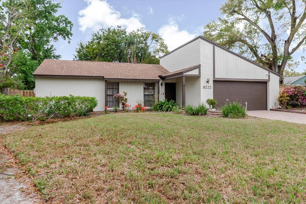A single-story house with a brown roof, stucco exterior, and an attached two-car garage — 8222 LA SERENA DRIVE, TAMPA, FL
