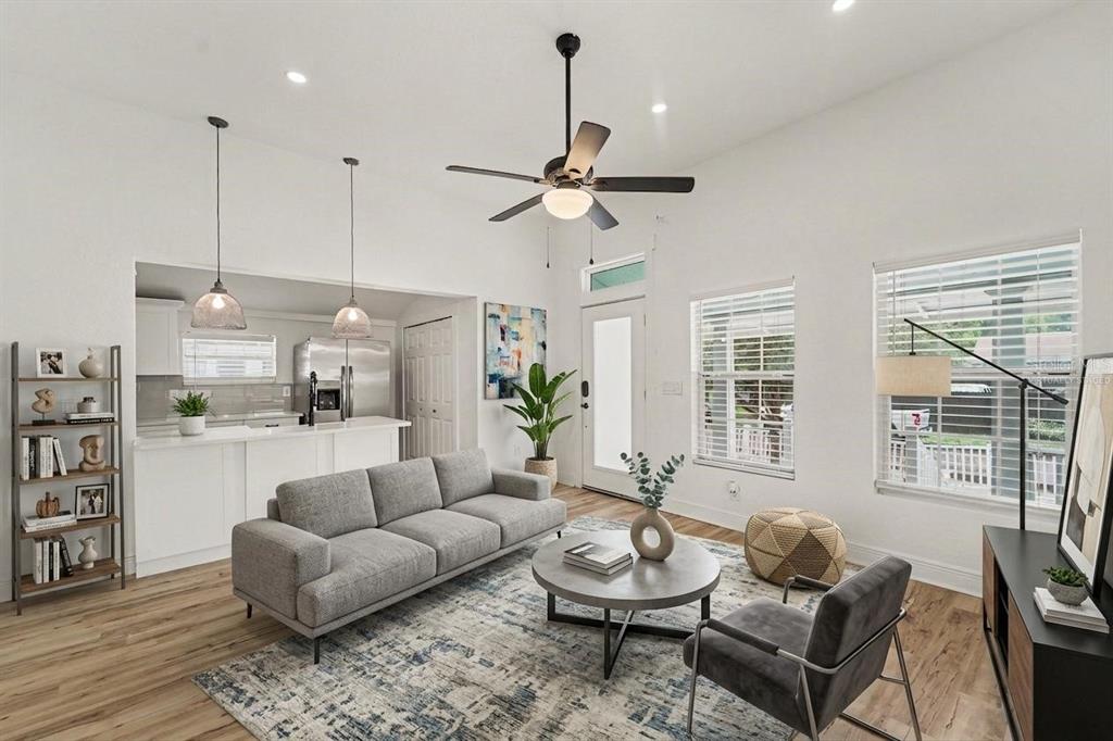 A living room with a gray sofa, area rug, and an open kitchen in the background — 800 E GENESEE STREET, TAMPA, FL