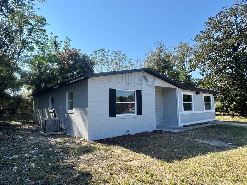A single-story house with light gray siding, a dark roof, and a concrete driveway — 7224 VALIANT COURT, ORLANDO, FL