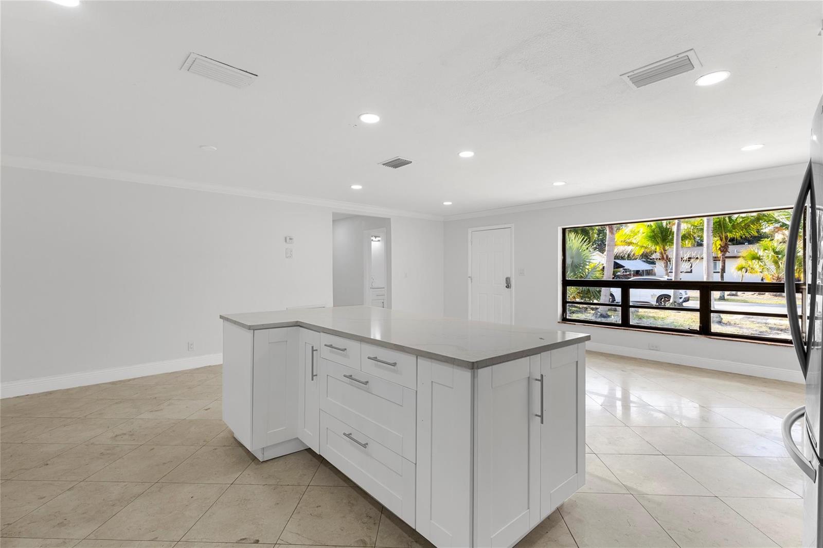 A white kitchen island with gray countertops sits in a room with tile flooring — 3313 SW 19th Street, Fort Lauderdale FL 33312, FORT LAUDERDALE, FL