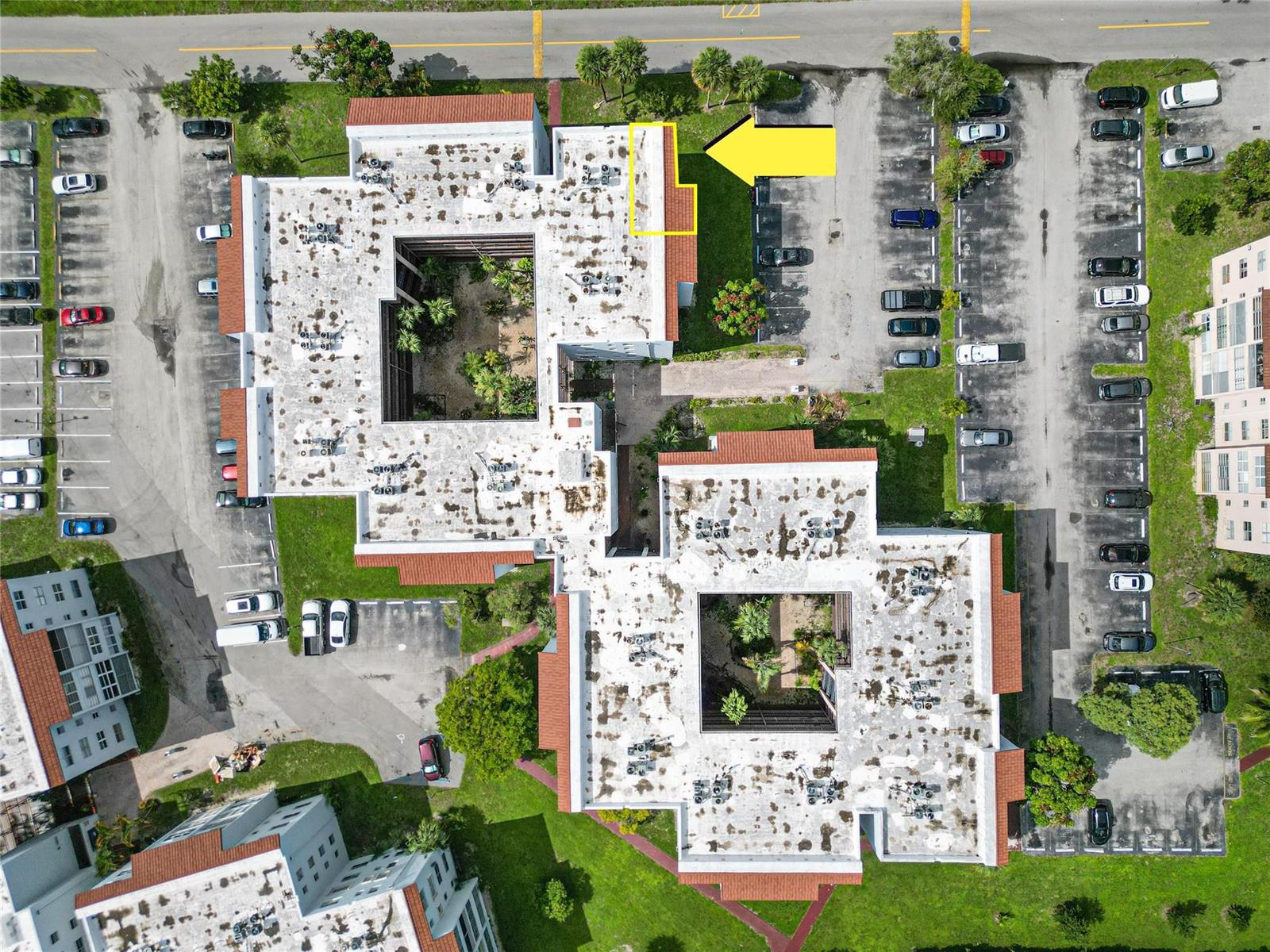 Aerial view of two multi-story apartment buildings with central courtyards and surrounding parking lots — 2850 Somerset Drive # 307L, Lauderdale Lakes FL 33311, LAUDERDALE LAKES, FL