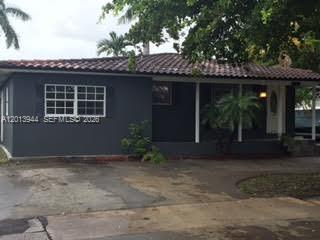 A dark gray single-story house with a tiled roof and a front porch — 335 NE 114th St # 1, Miami FL 33161, MIAMI, FL