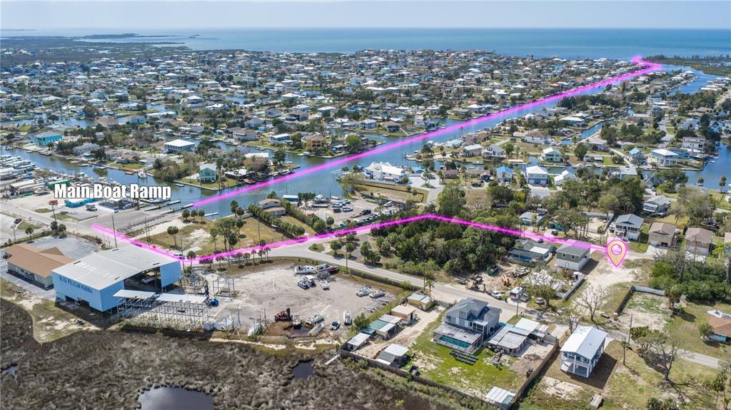An aerial view shows a coastal neighborhood with a marina, boat ramp, and highlighted property — 5056 OAK LEAF LANE, HERNANDO BEACH, FL
