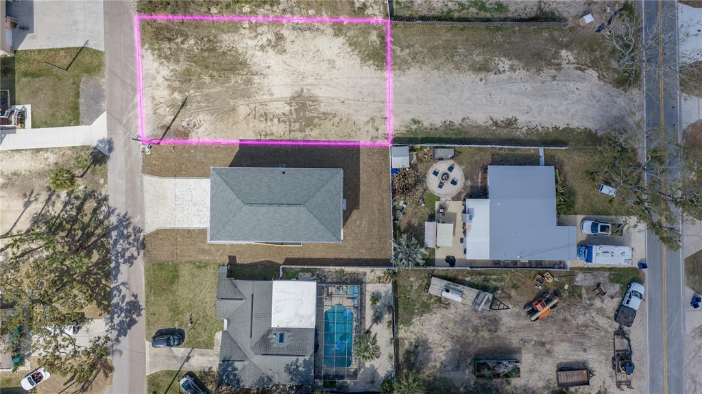 An aerial view shows a vacant rectangular lot outlined in pink next to residential houses — 5056 OAK LEAF LANE, HERNANDO BEACH, FL