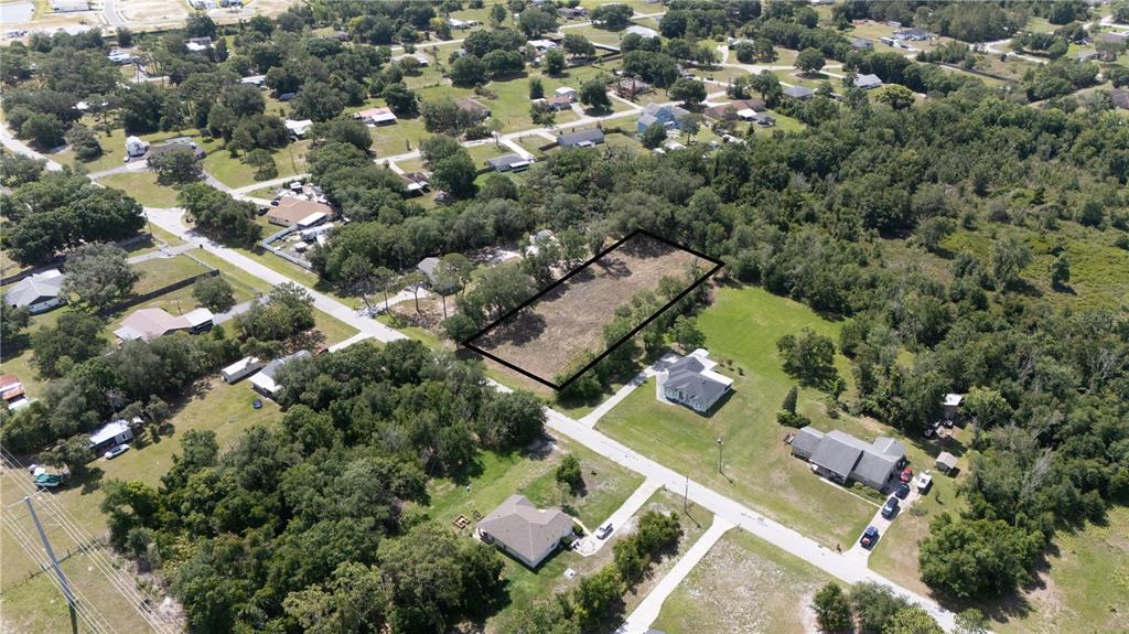 An aerial view shows a vacant rectangular lot outlined in black within a residential neighborhood — 0 HEDGEROW DRIVE, WESLEY CHAPEL, FL
