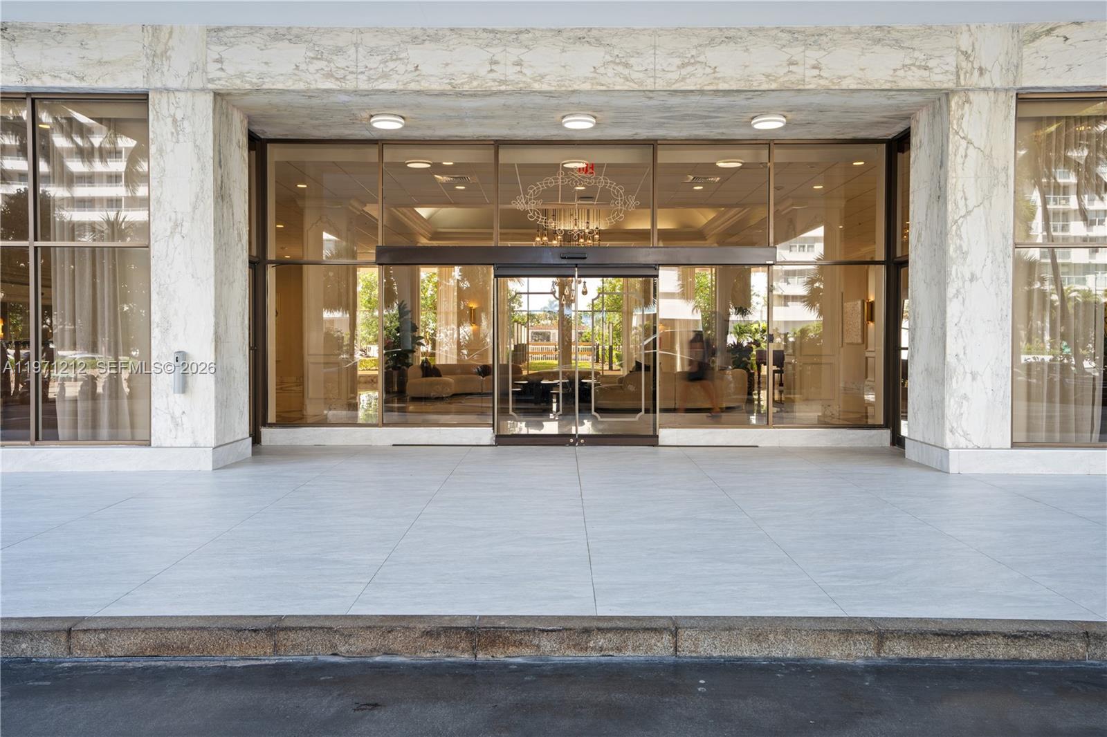A bathroom features a white toilet, a bidet, and a shower with a white curtain — 5600 Collins Ave # 16Y, Miami Beach FL 33140, MIAMI BEACH, FL