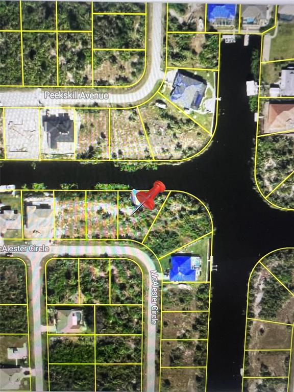 This is an aerial map view showing residential lots and a canal in a neighborhood — 10432 MCALESTER CIRCLE, PORT CHARLOTTE, FL
