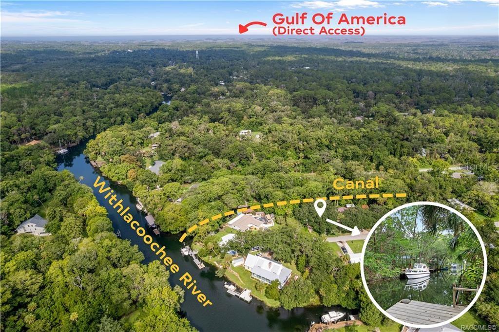 An aerial view shows a house situated between the Withlacoochee River and a canal — 68 CANTERBURY ROAD, INGLIS, FL
