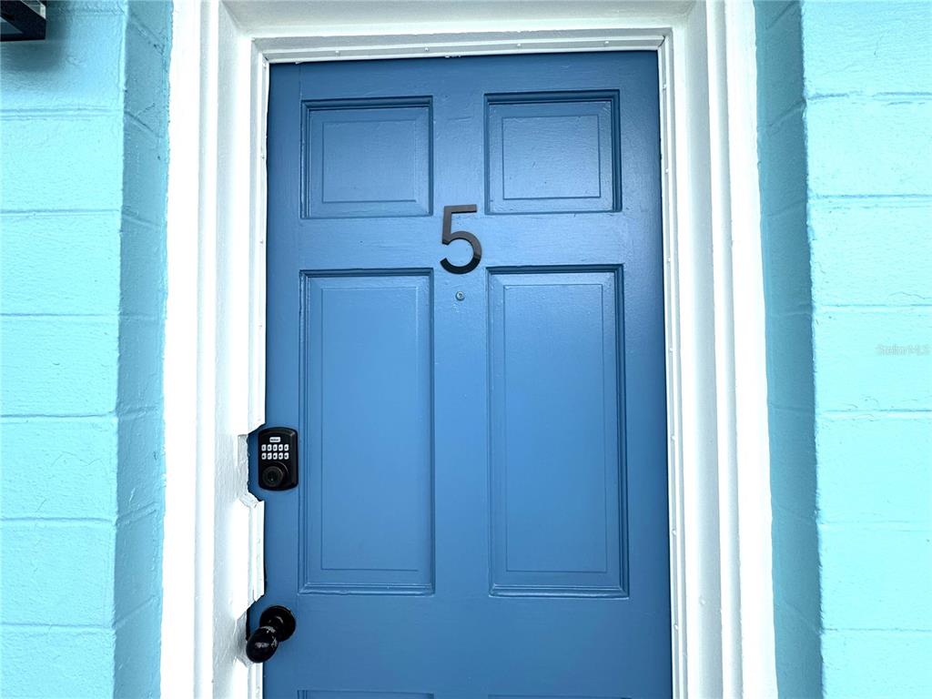 A blue exterior door with the number five and a digital keypad lock — 13343 GULF BOULEVARD UNIT B5, MADEIRA BEACH, FL