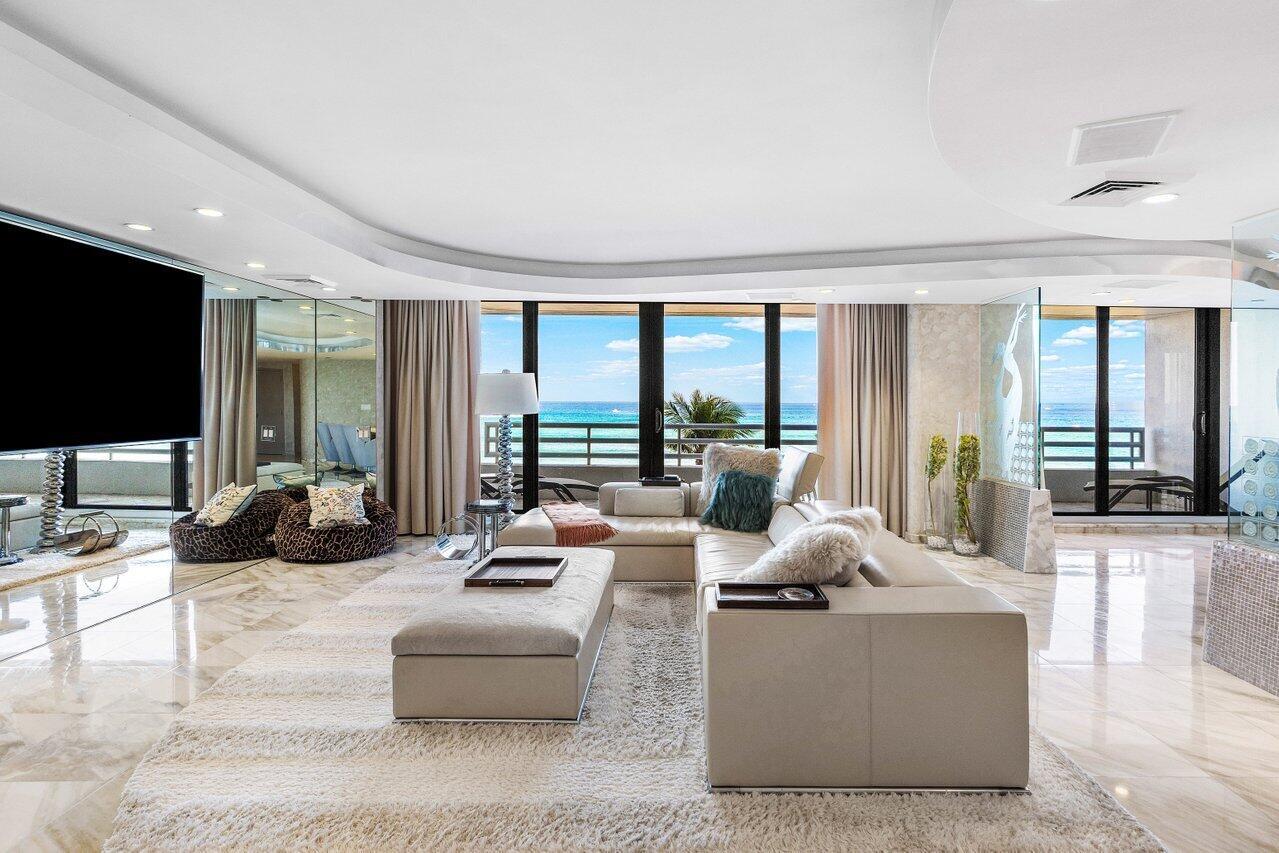 A living room with a large sectional sofa, marble floors, and floor-to-ceiling windows overlooking the ocean — 1500 S Ocean Boulevard, Boca Raton FL 33432, BOCA RATON, FL