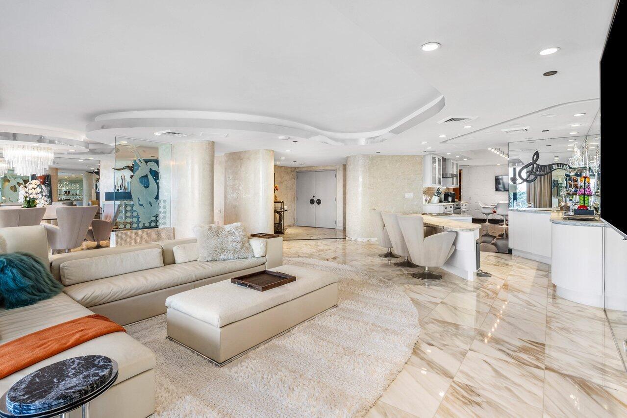 A modern, open-concept living area features marble floors, a white sectional sofa, and a kitchen island — 1500 S Ocean Boulevard, Boca Raton FL 33432, BOCA RATON, FL