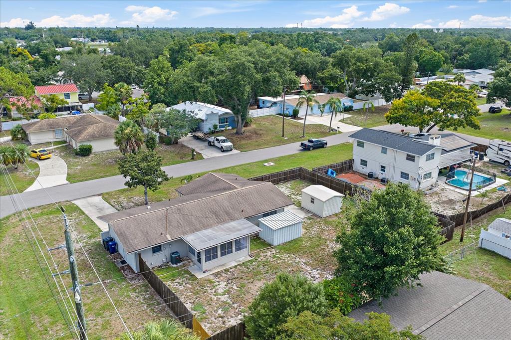 An aerial view shows a single-story house with a fenced yard and a detached shed — 1210 DORIS DRIVE, SARASOTA, FL