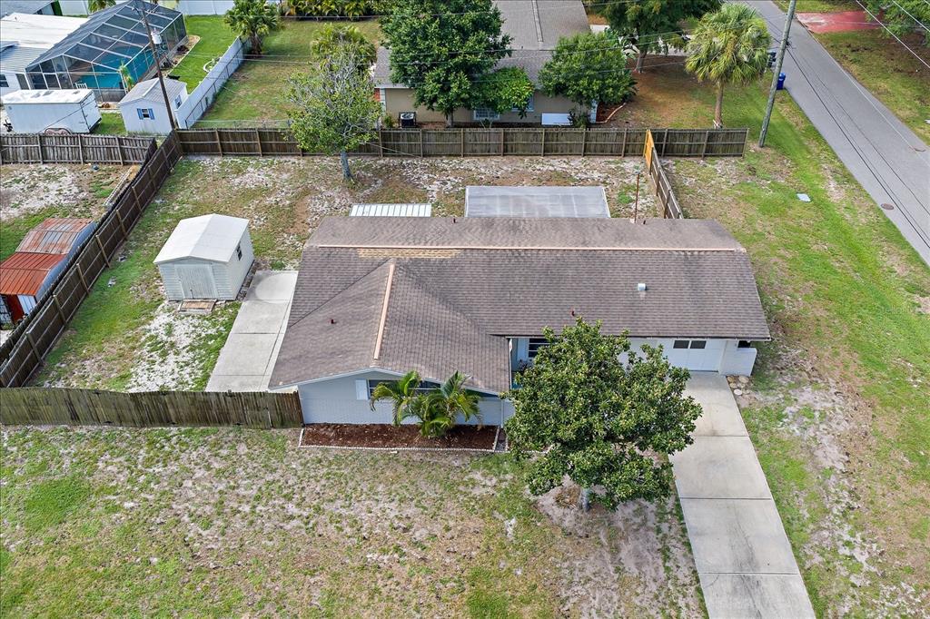 An aerial view shows a single-story house with a fenced yard and a storage shed — 1210 DORIS DRIVE, SARASOTA, FL