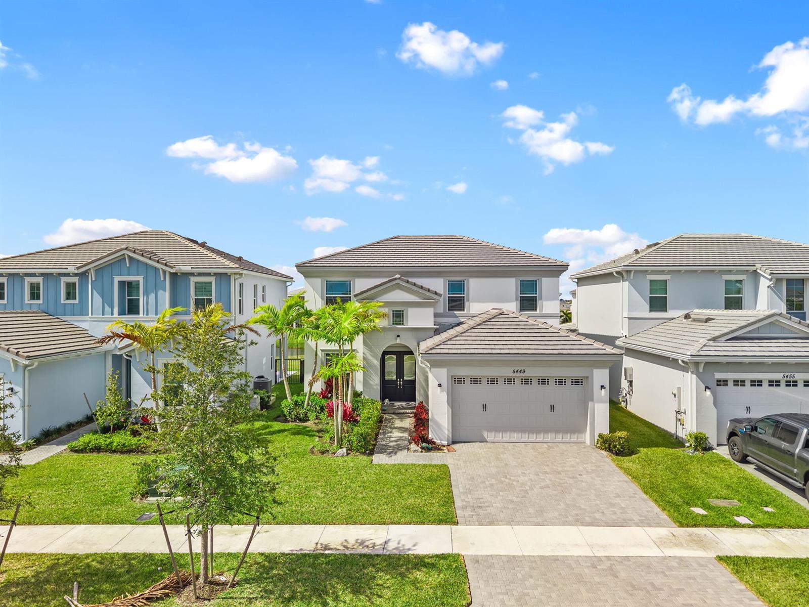 A two-story suburban house with a gray tiled roof and a paved driveway — 5449 Empire Drive, Westlake FL 33470, WESTLAKE, FL