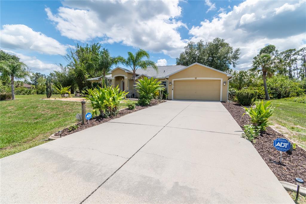 A single-story house with a beige stucco exterior and a concrete driveway — 5769 E PRICE BOULEVARD, NORTH PORT, FL